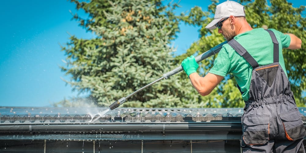 Man Powerwashing Gutter
