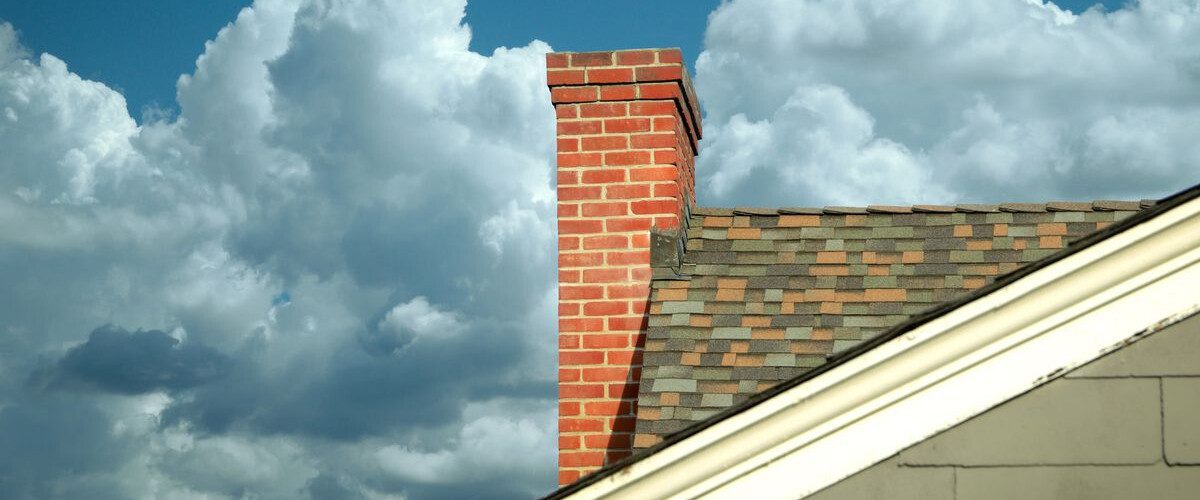 Chimney on rooftop and clouds